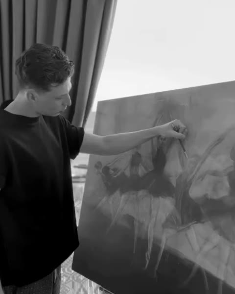 Emir Tekkalmaz working on a dark canvas of dancers at the residency studio.