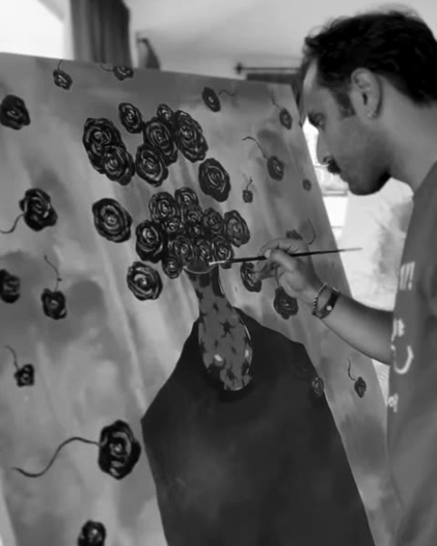 Yağız Seis painting the roses of his canvas at the residency.